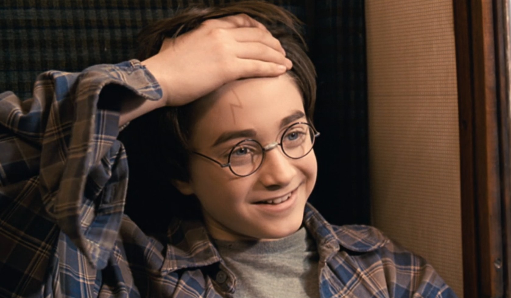Daniel Radcliffe as Harry Potter shows Ron the scar on his forehead