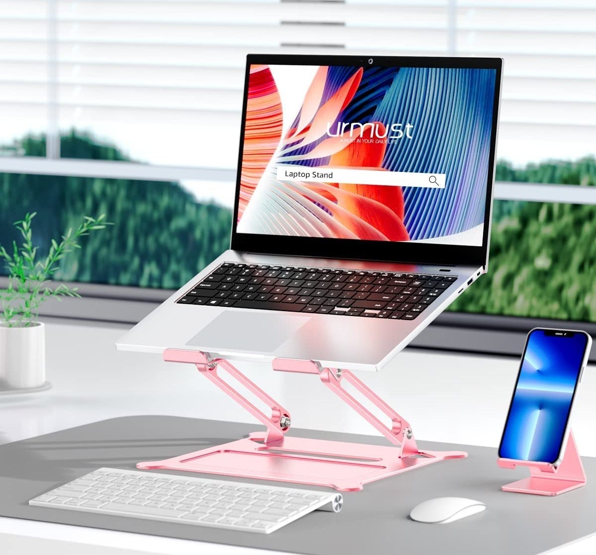 a laptop lifted on a laptop stand