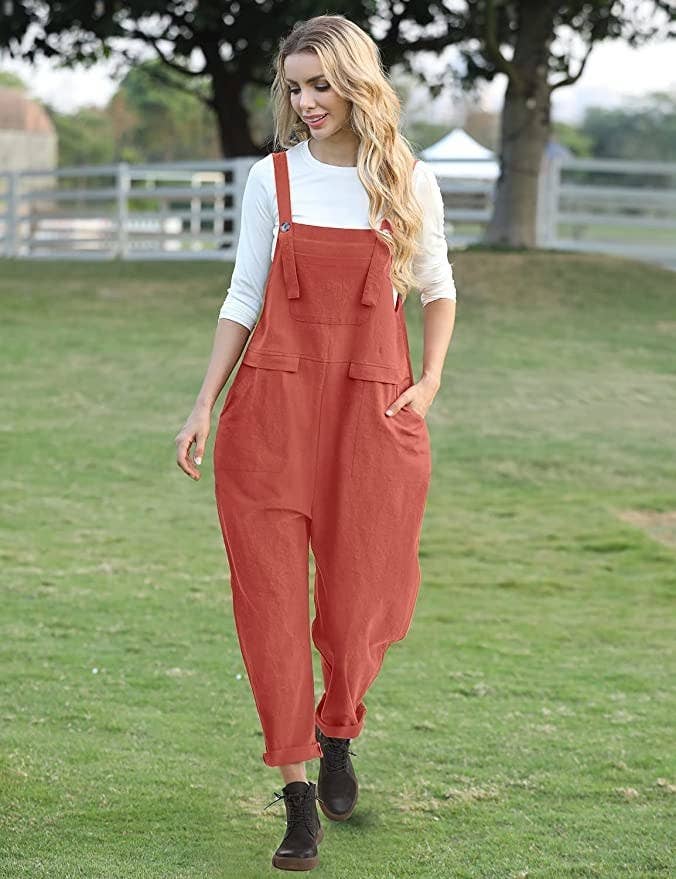 a model wearing the overalls with boots in an open field