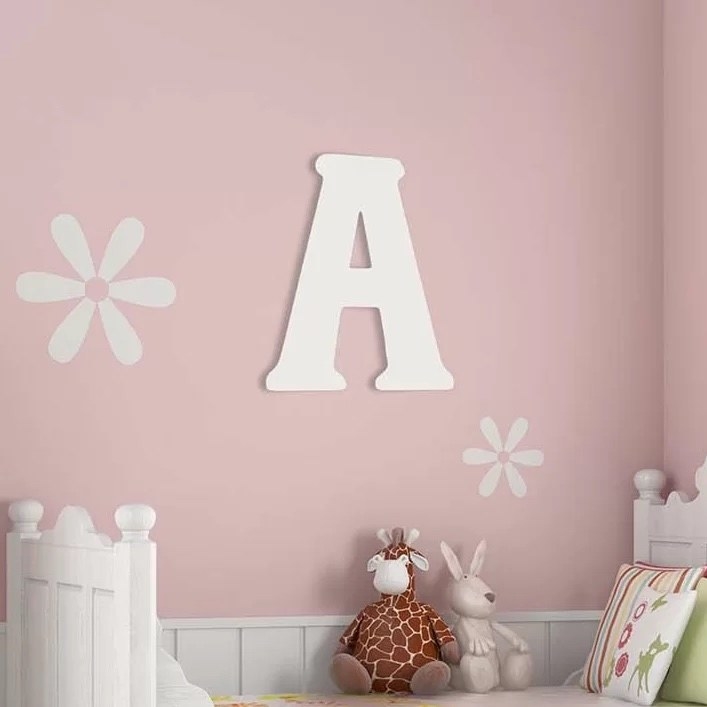 A white letter A on a pink wall