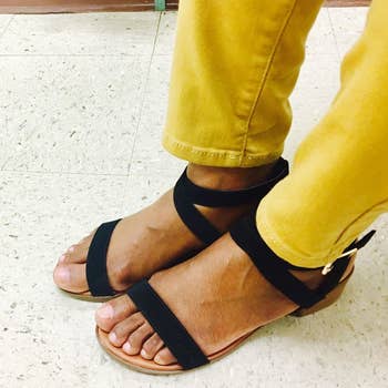 a reviewer wearing the same sandals in black