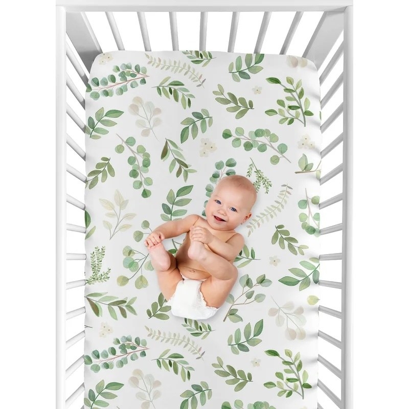 a baby in the crib with the crib sheet