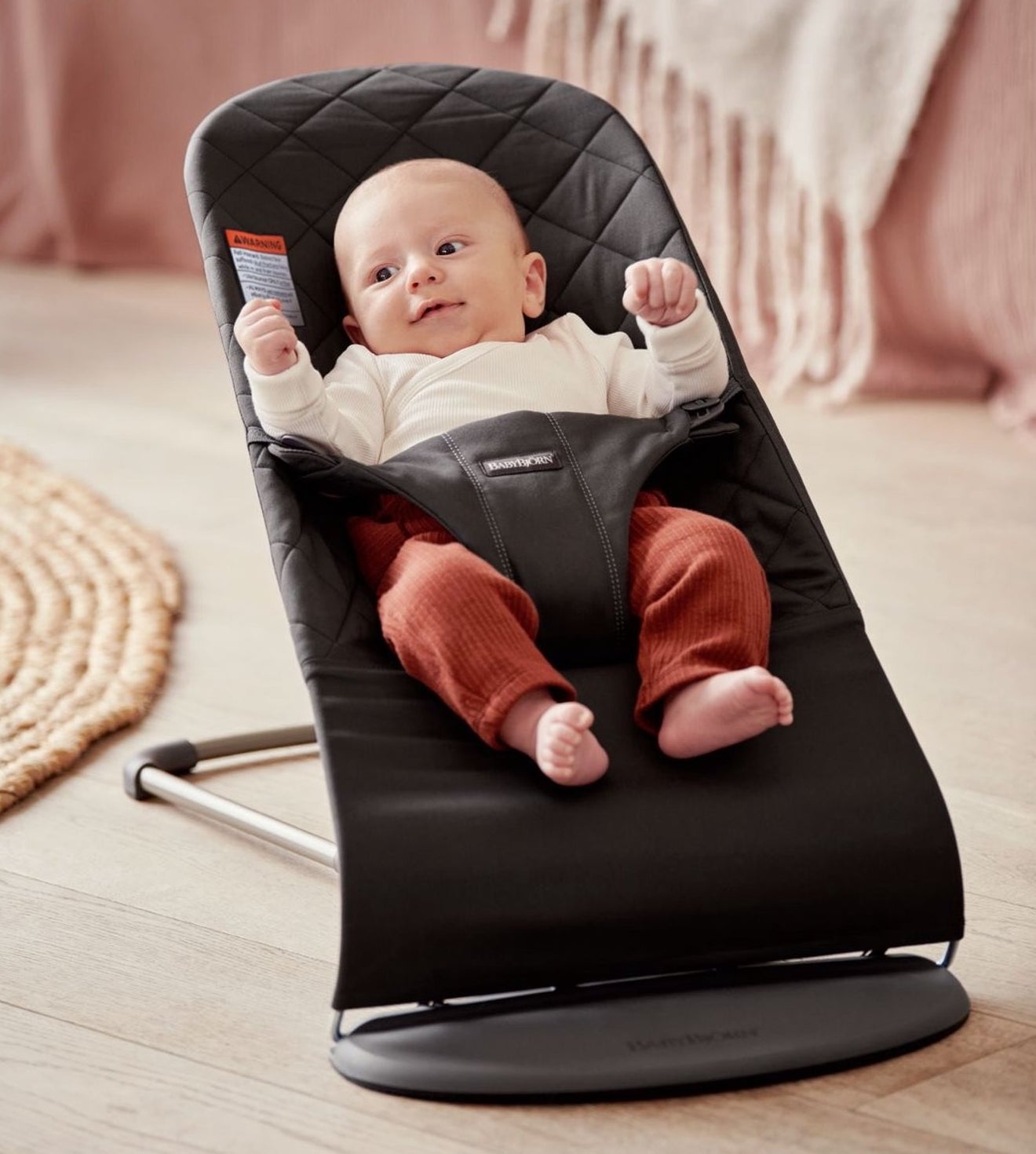 baby sits in bouncer