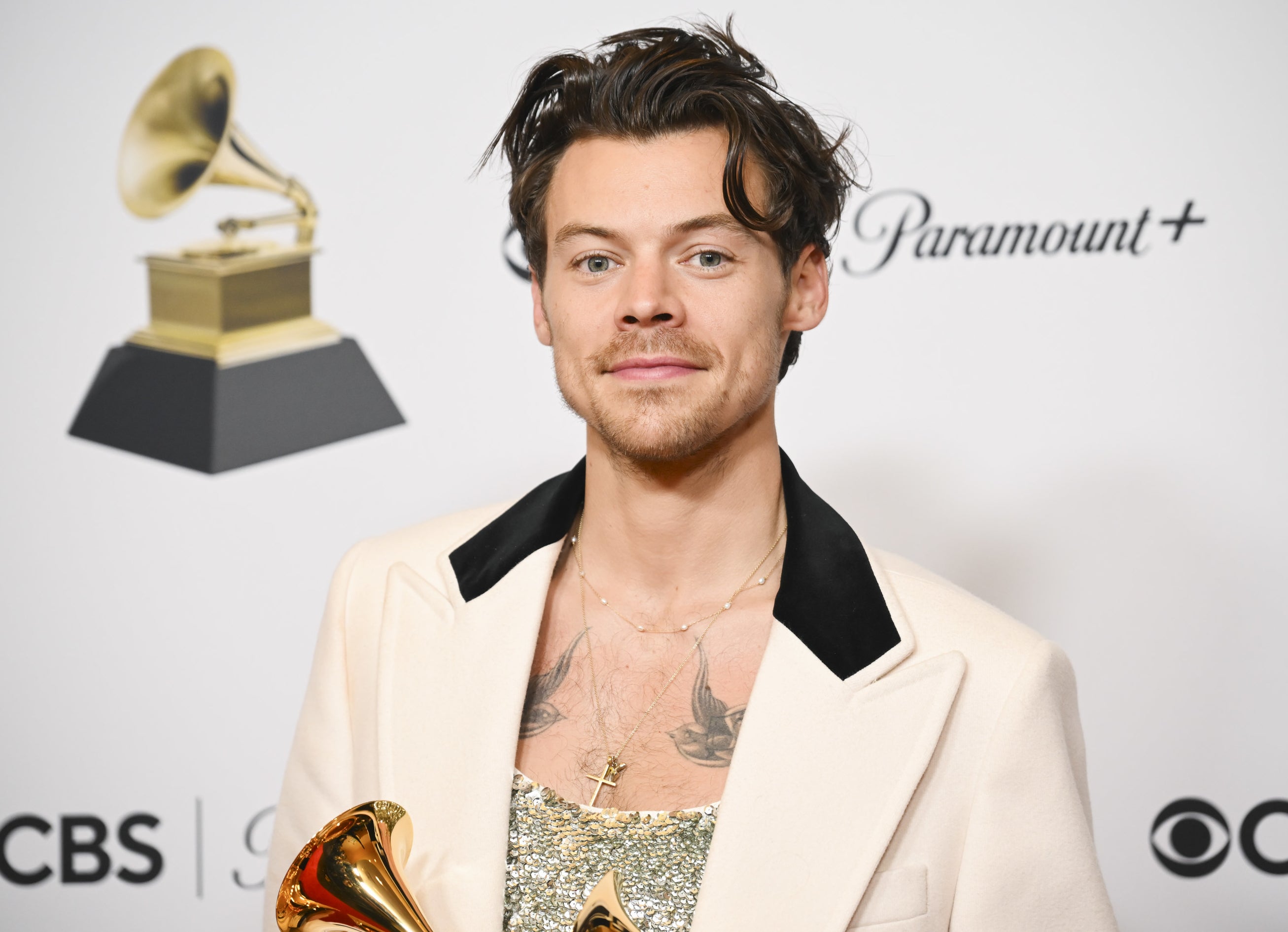 A close-up of Harry holding a Grammy