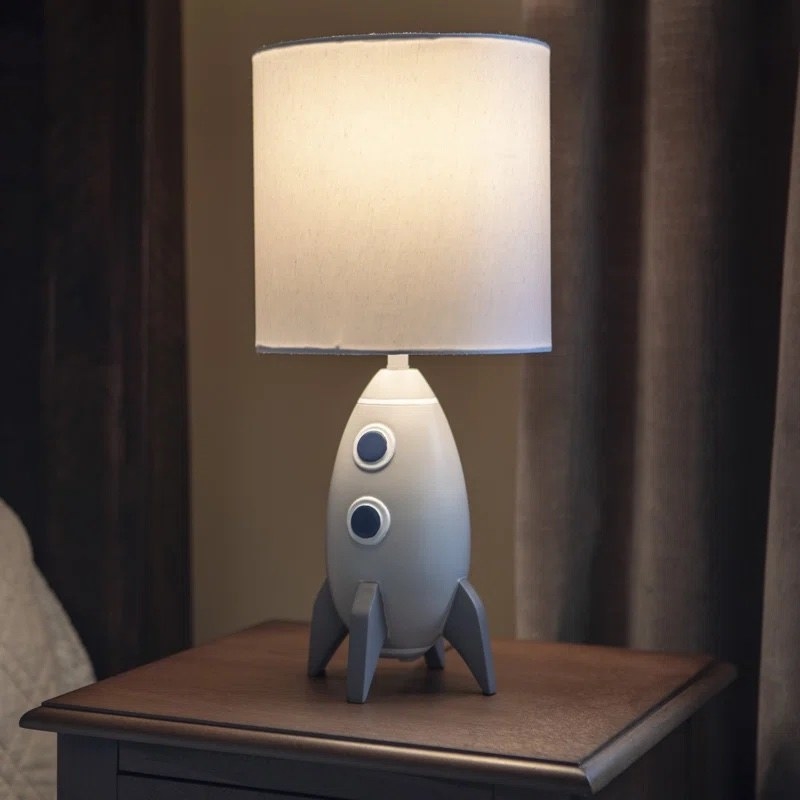 the rocketship lamp lit up in the dark