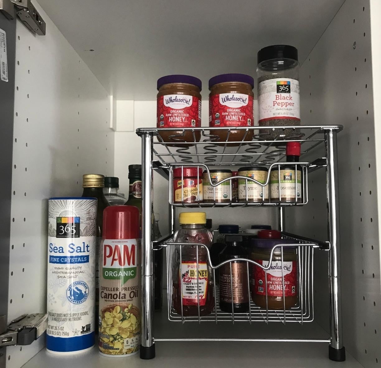 Reviewer image of organizer filled with pantry staples in a cabinet
