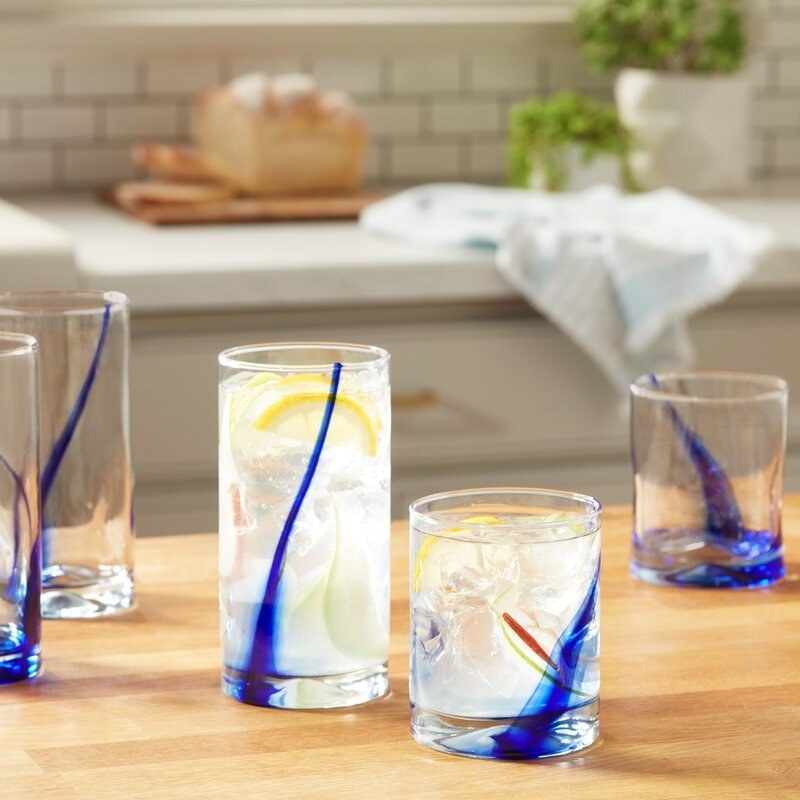 the glasses in both the tall and short size with a blue design streaking diagonally