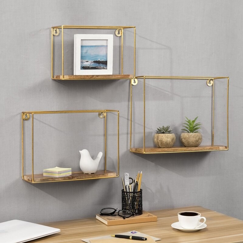 the shadow box shelves trimmed with gold