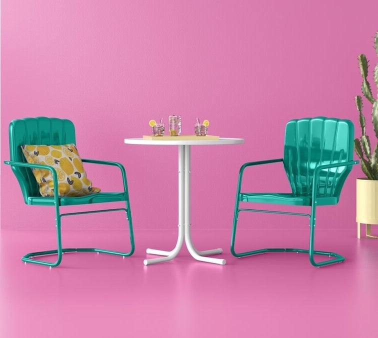 the two vibrant green chairs and slim white table