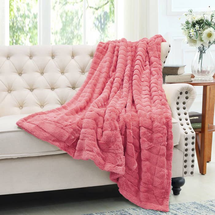 the plush faux fur blanket in a vibrant coral
