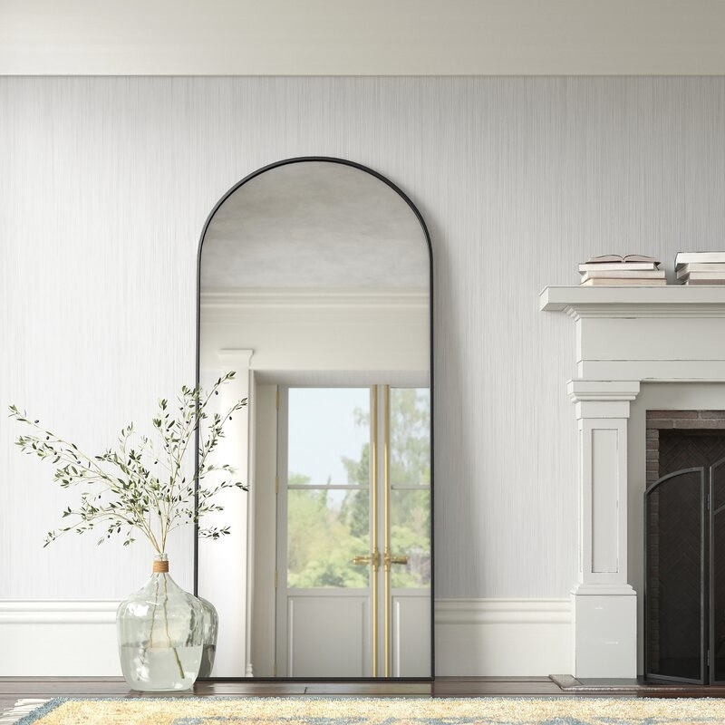 the arched floor mirror lined in black