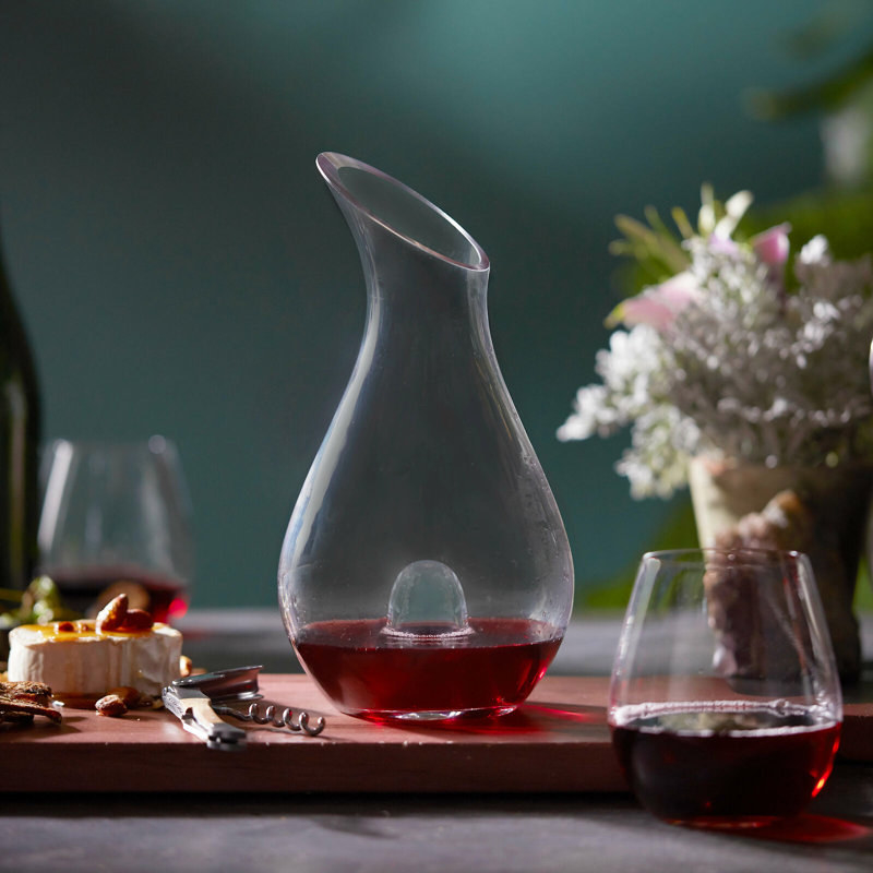 the wine decanter that is a curved design with a hole in the center