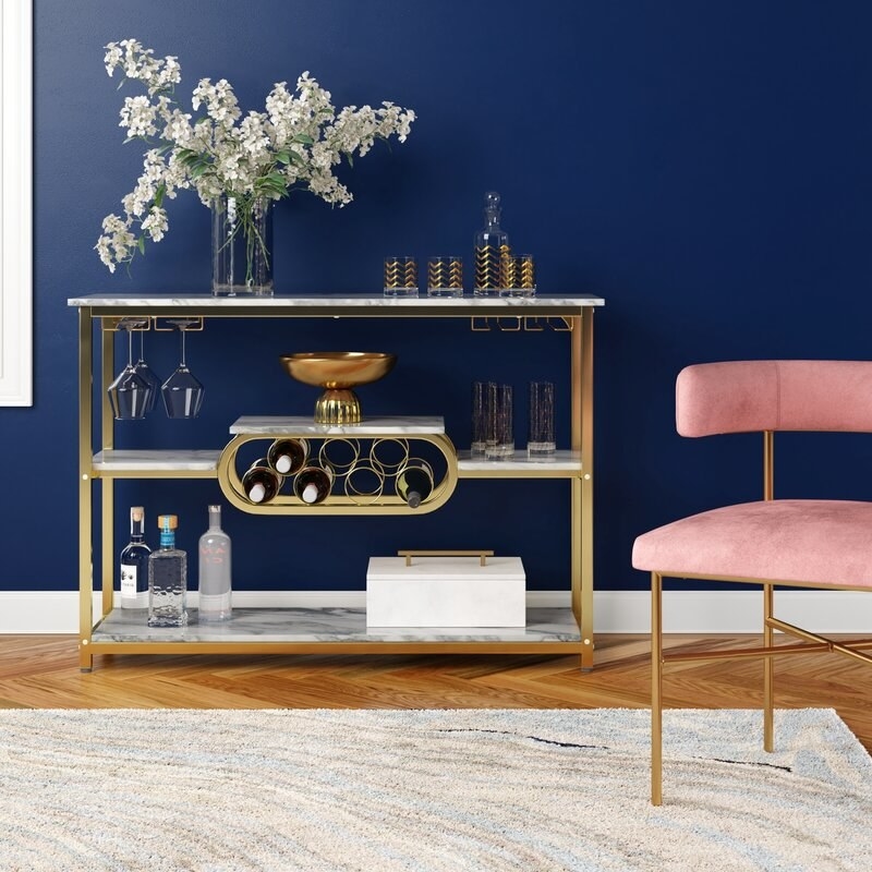 the gold metal and marble bar shelf