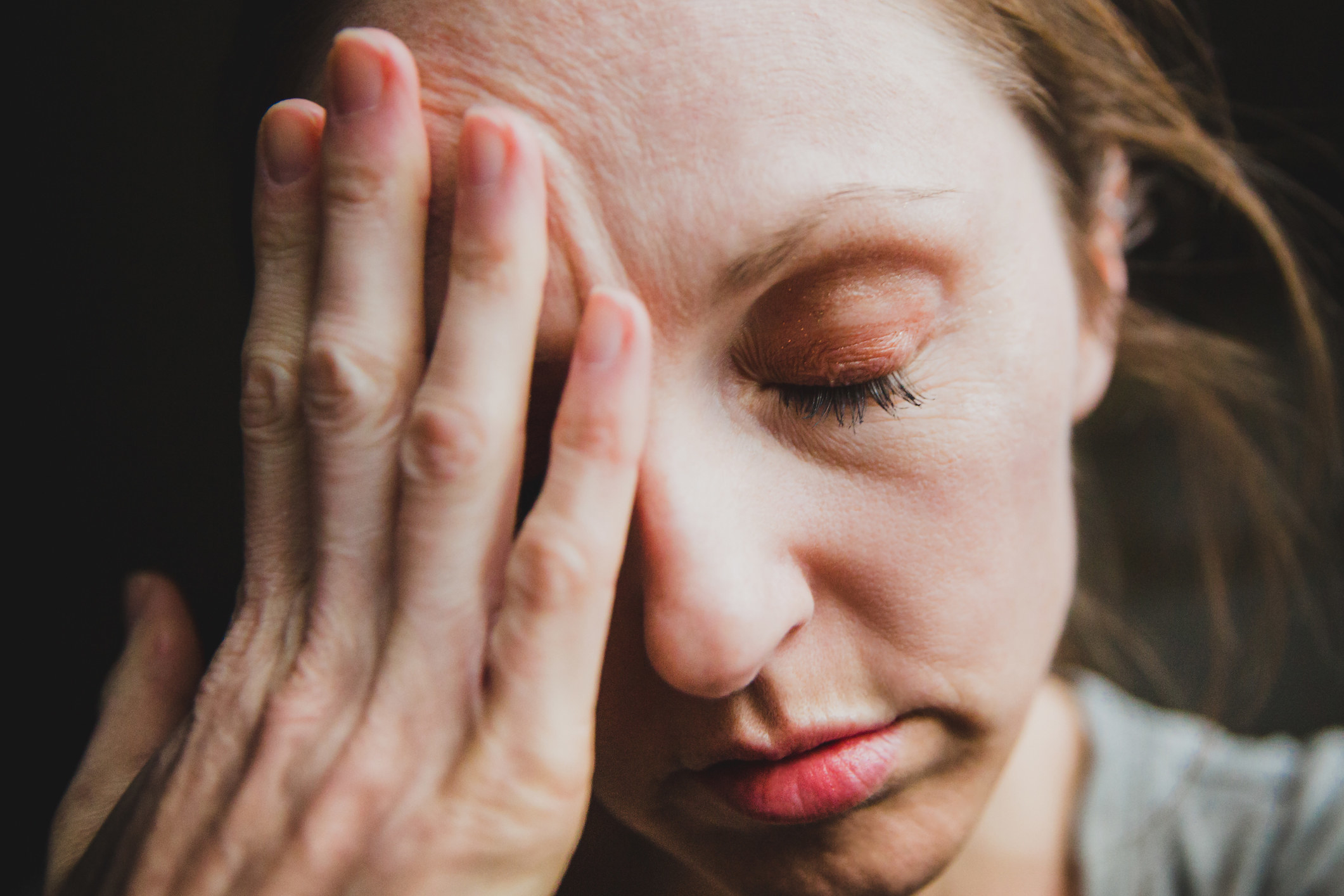 woman with her hand to her forehead in frustration