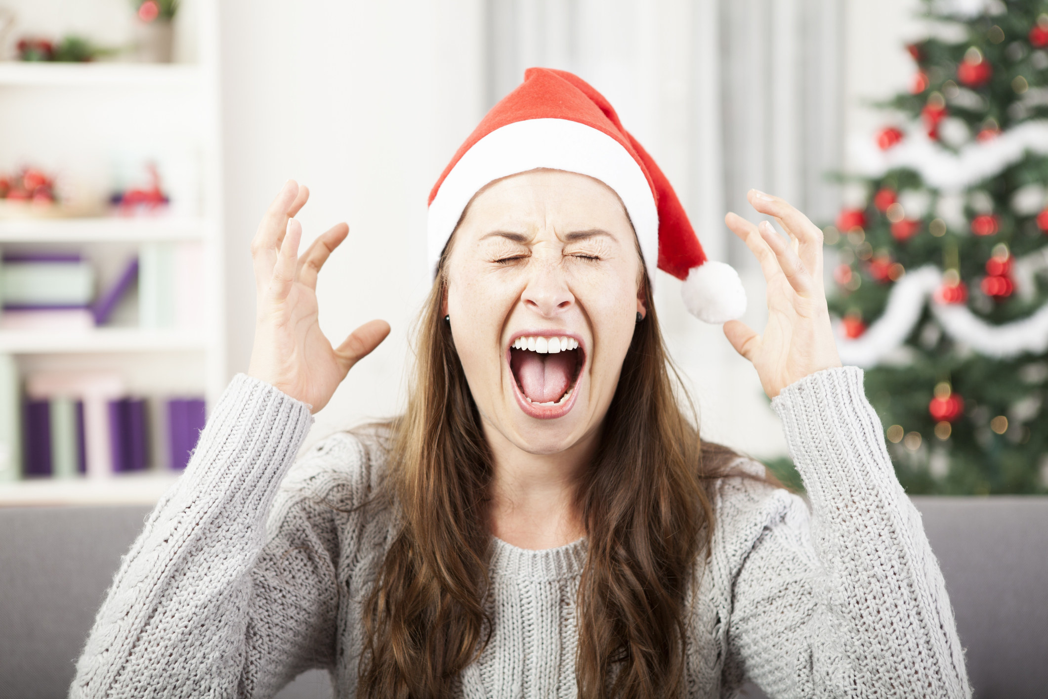 woman yelling wearing a santa hat