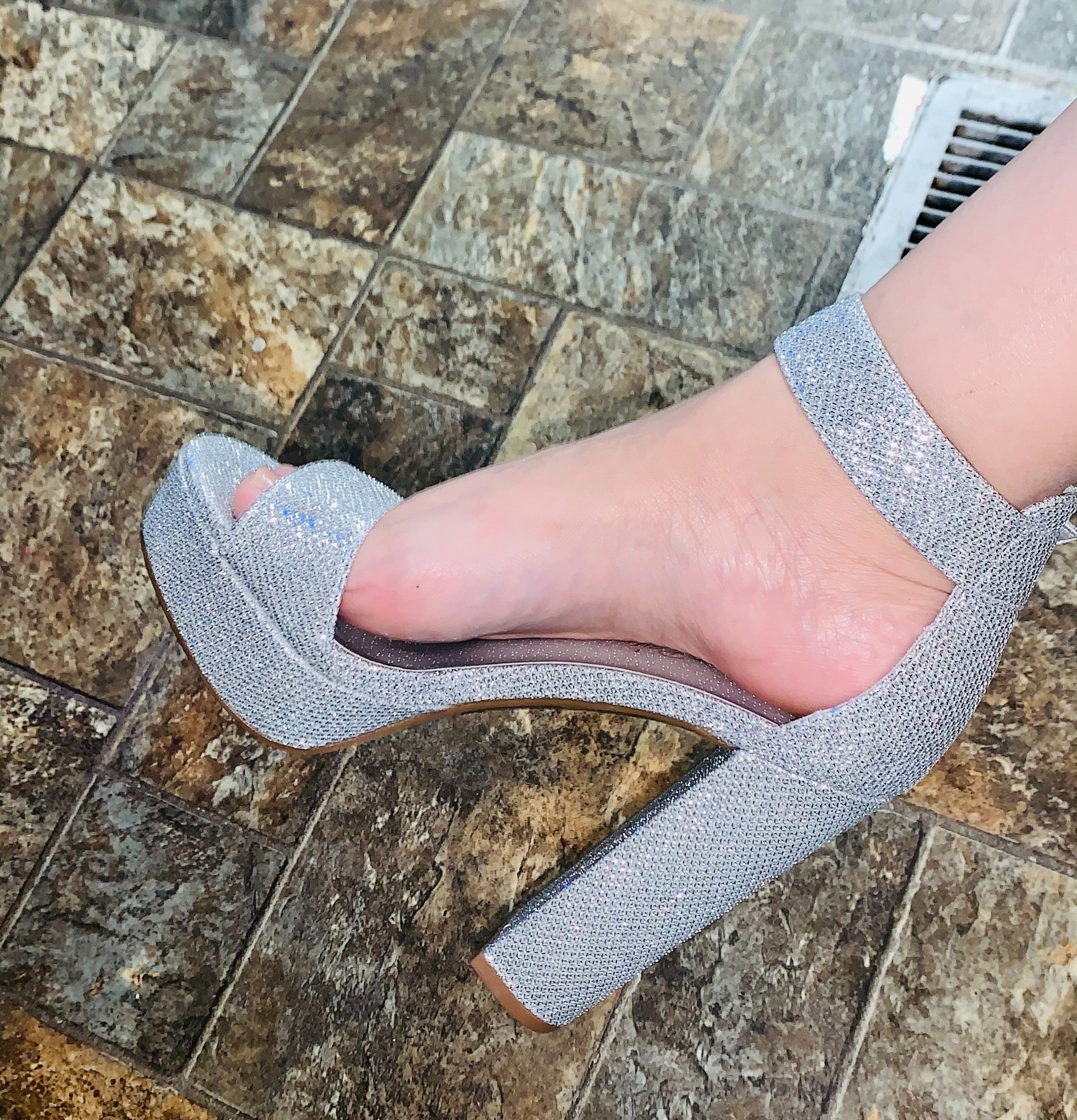 a reviewer wearing the silver heel