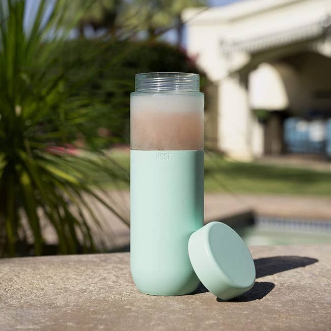 a light blue silicone grip around an insulated water bottle