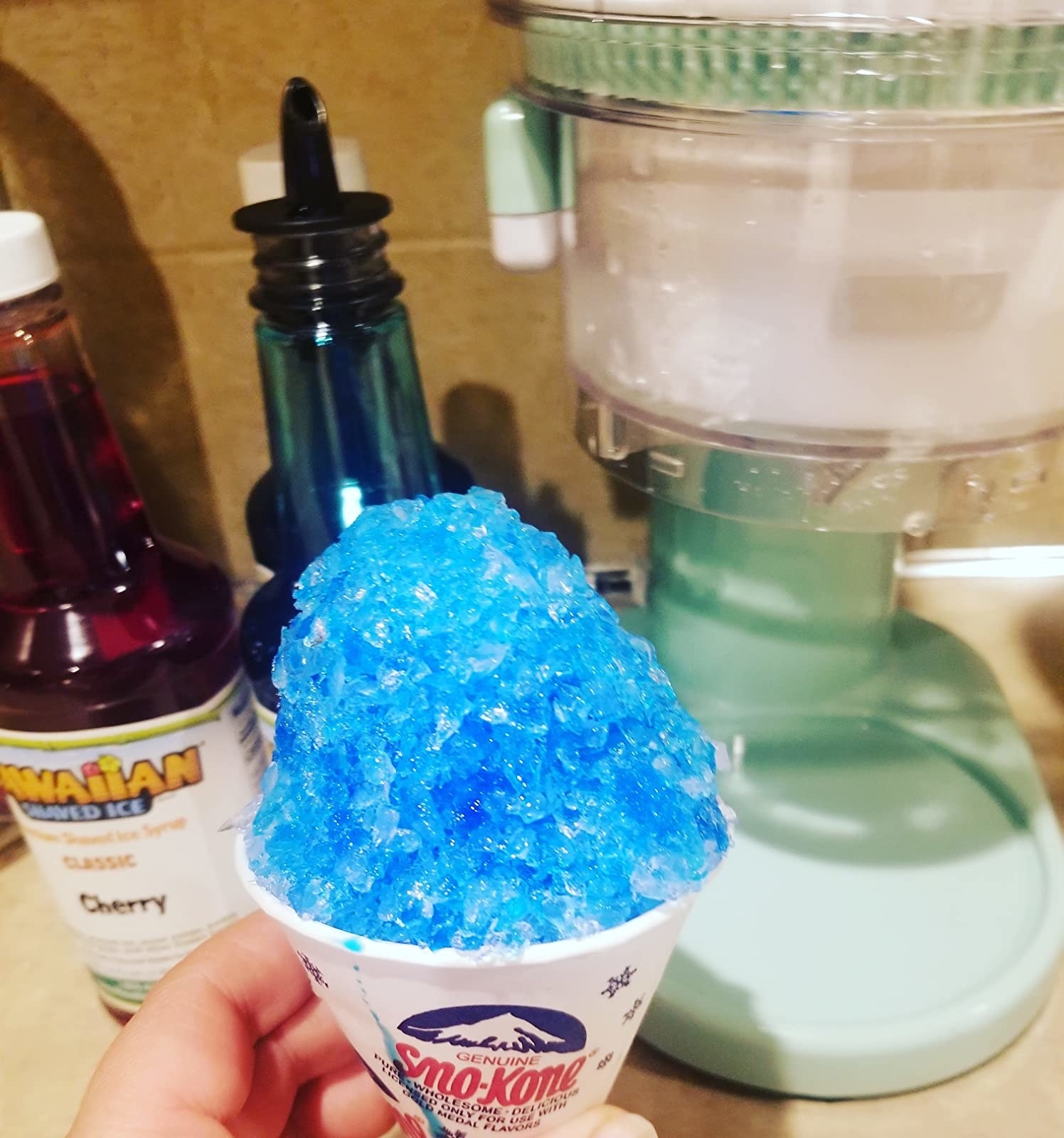 Reviewer holding cup of blue shaved ice