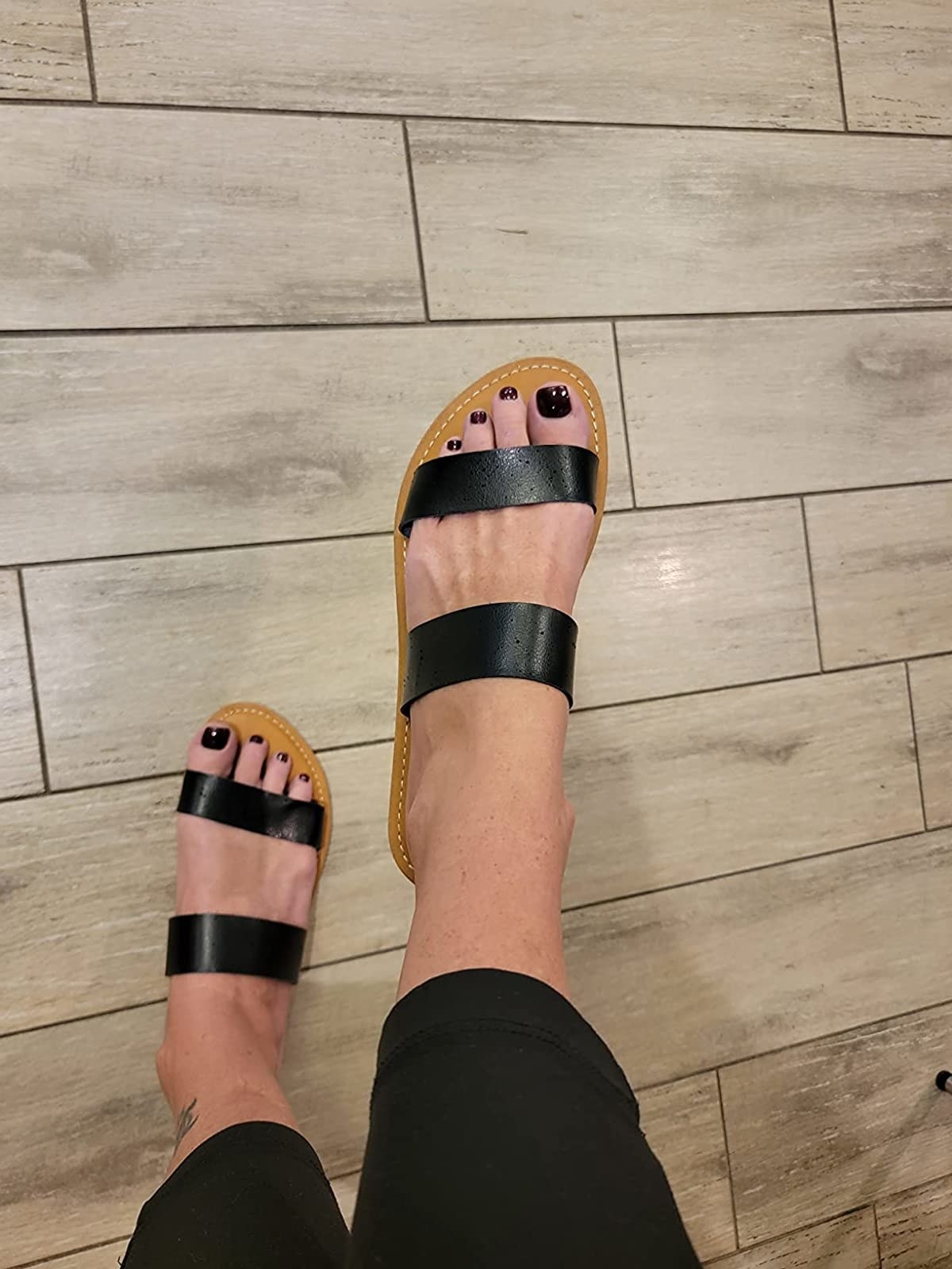 Reviewer wearing the black sandals