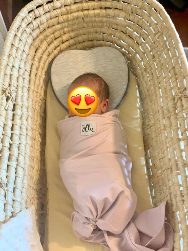 reviewer's baby in pink swaddle