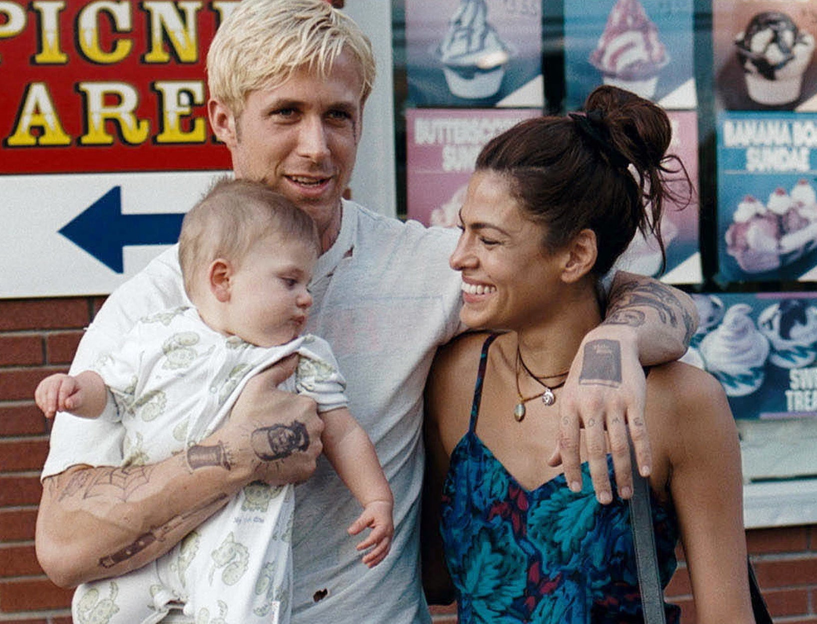Eva and Ryan pose together on set with an infant