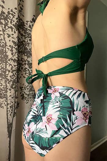 Image of reviewer wearing green floral bathing suit