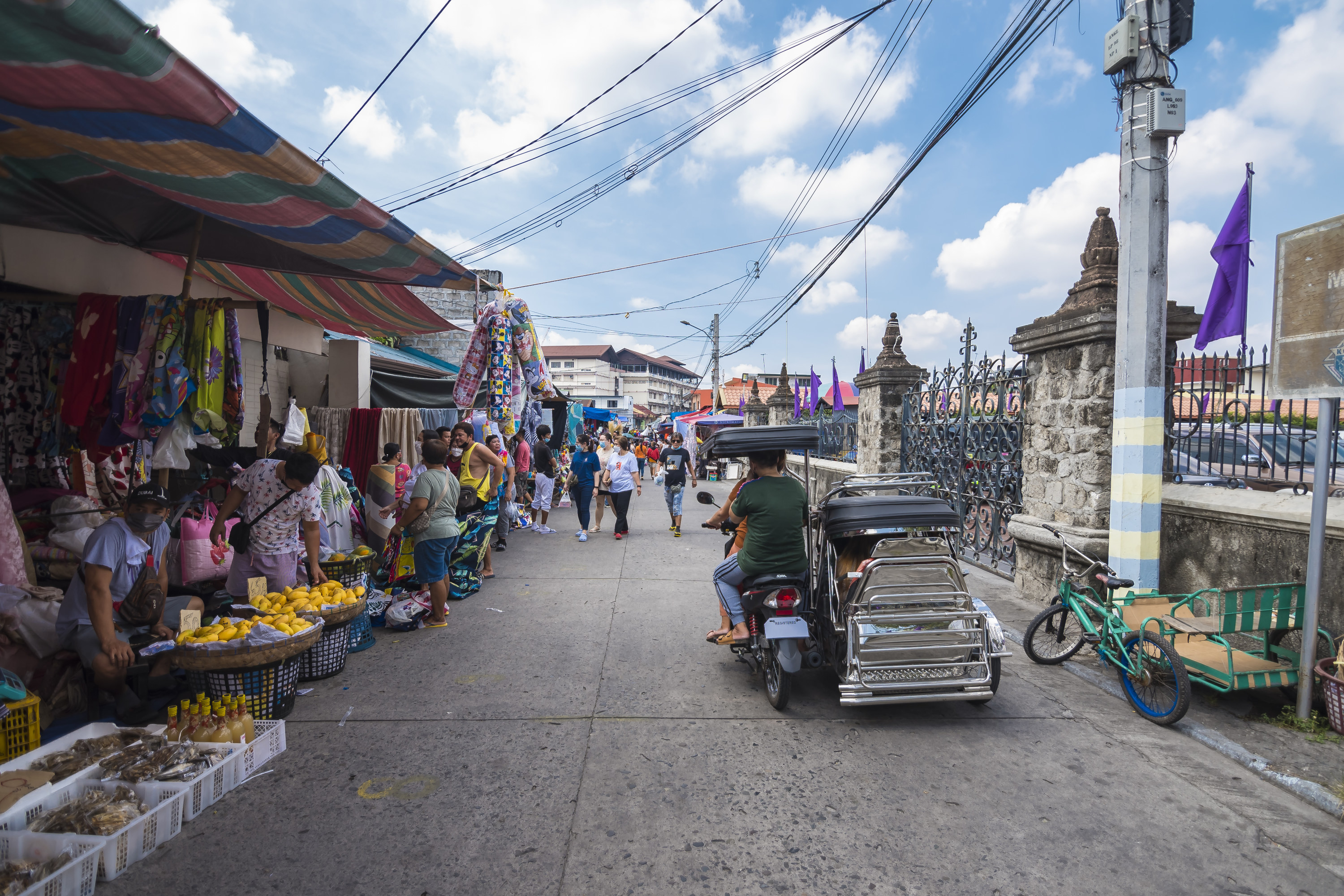 a tricycle passing by the local market scene in the phillippines