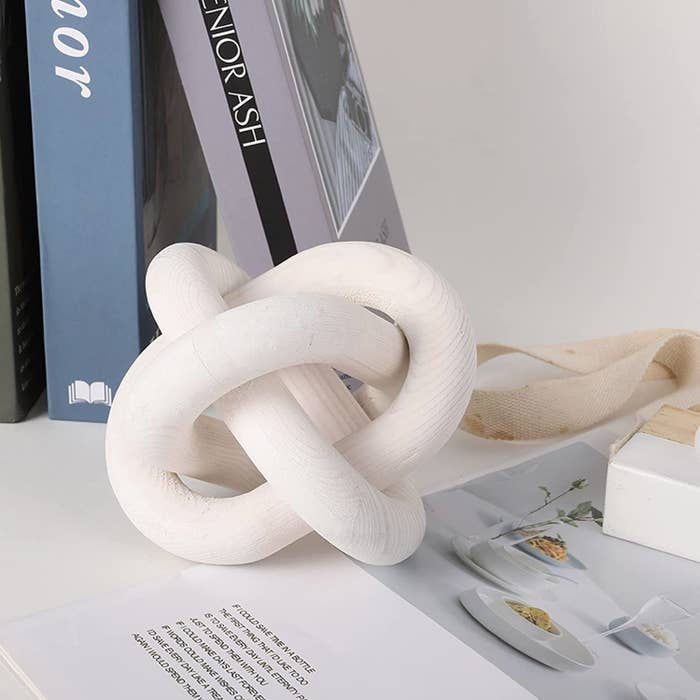 the wooden knot next to books