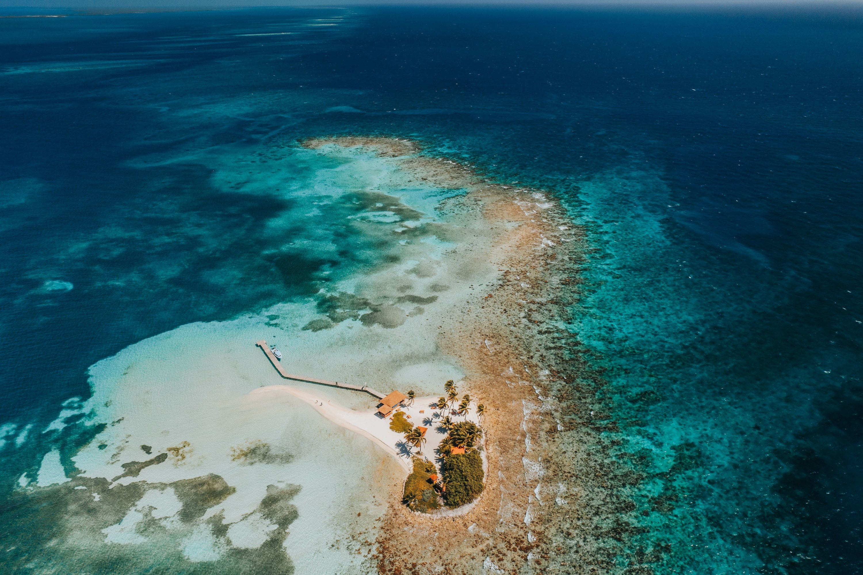 A breathtaking bird&#x27;s eye view of a small island in Belize surrounded by Caribbean Sea