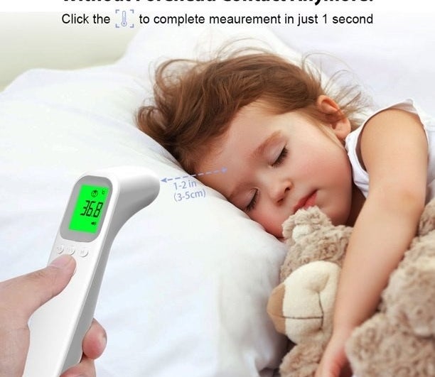 Sleeping child getting their temperature reading