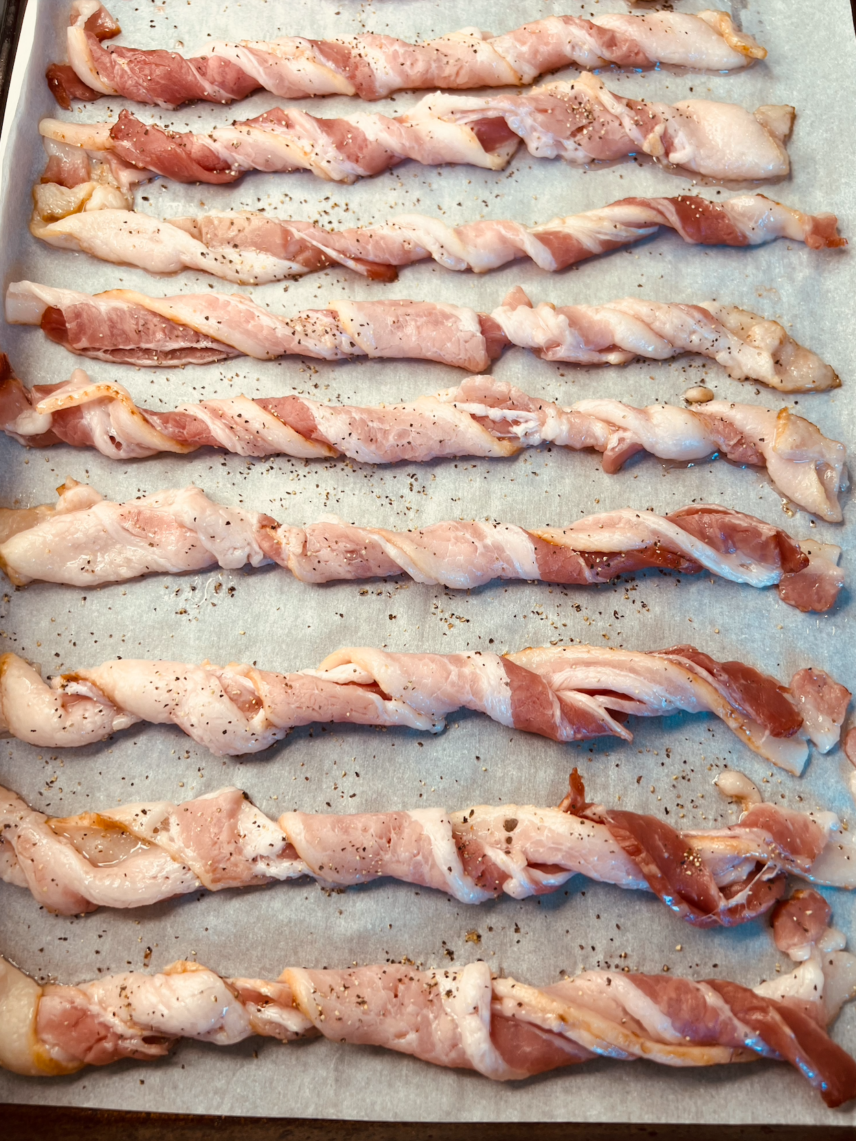 Twisted bacon on a baking sheet