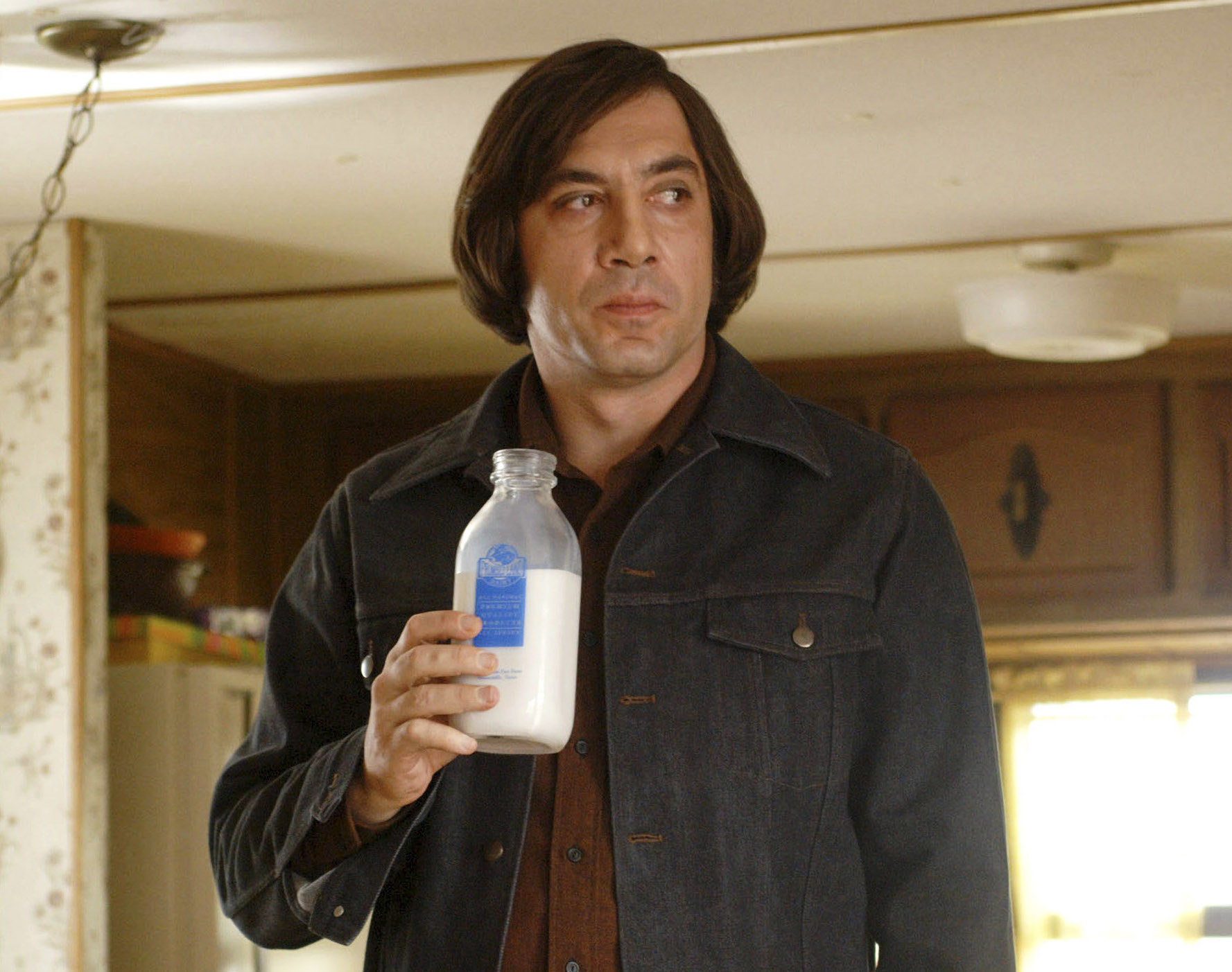 Javier Bardem drinks a glass bottle of milk in No Country for Old Men
