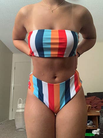 Imageo f reviewer wearing striped bathing suit