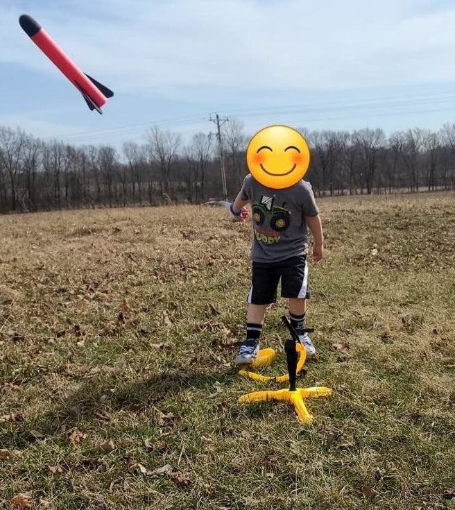 Kid launching rocket outsode