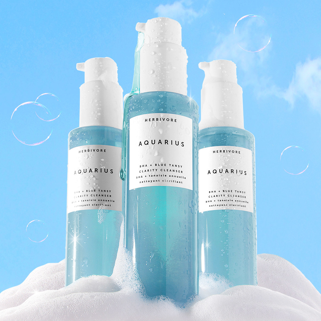 containers of Herbivore Aquarius filled with blue cleansing solution