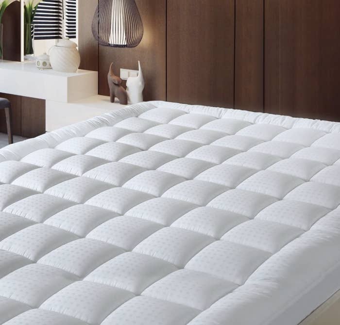 the mattress topper on a bed in a room