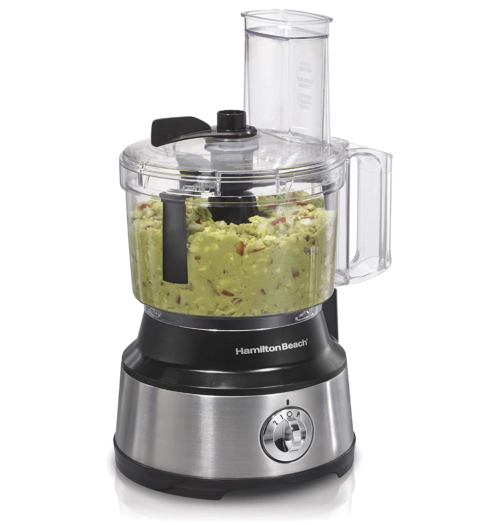 the food processor with guacamole inside of it in front of a plain background