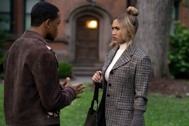 Tariq and Lauren (Paige Hurd), in a tweed jacket and turtleneck, standing on campus