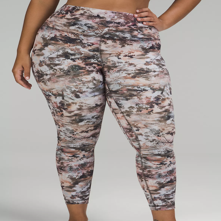 a model wearing printed leggings in front of a plain background