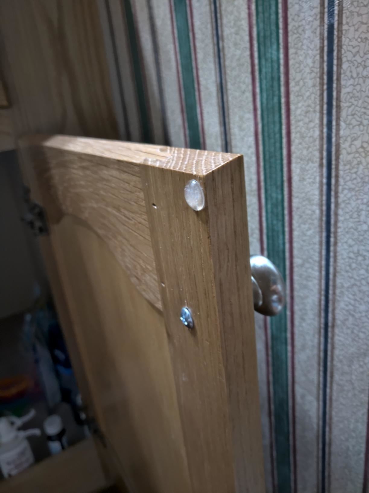Reviewer's unfastened  furniture  doorway  with the bumper connected  the borderline   of the furniture  door