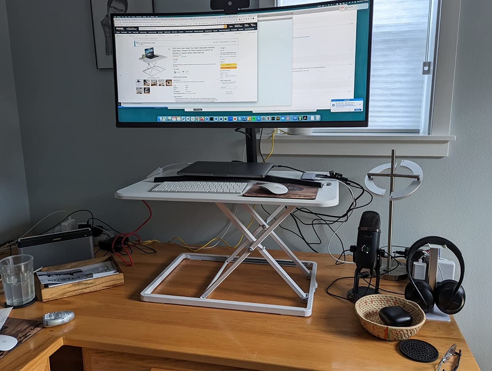 A reviewer&#x27;s converter on their desk with a monitor, keyboard, and mousepad on top