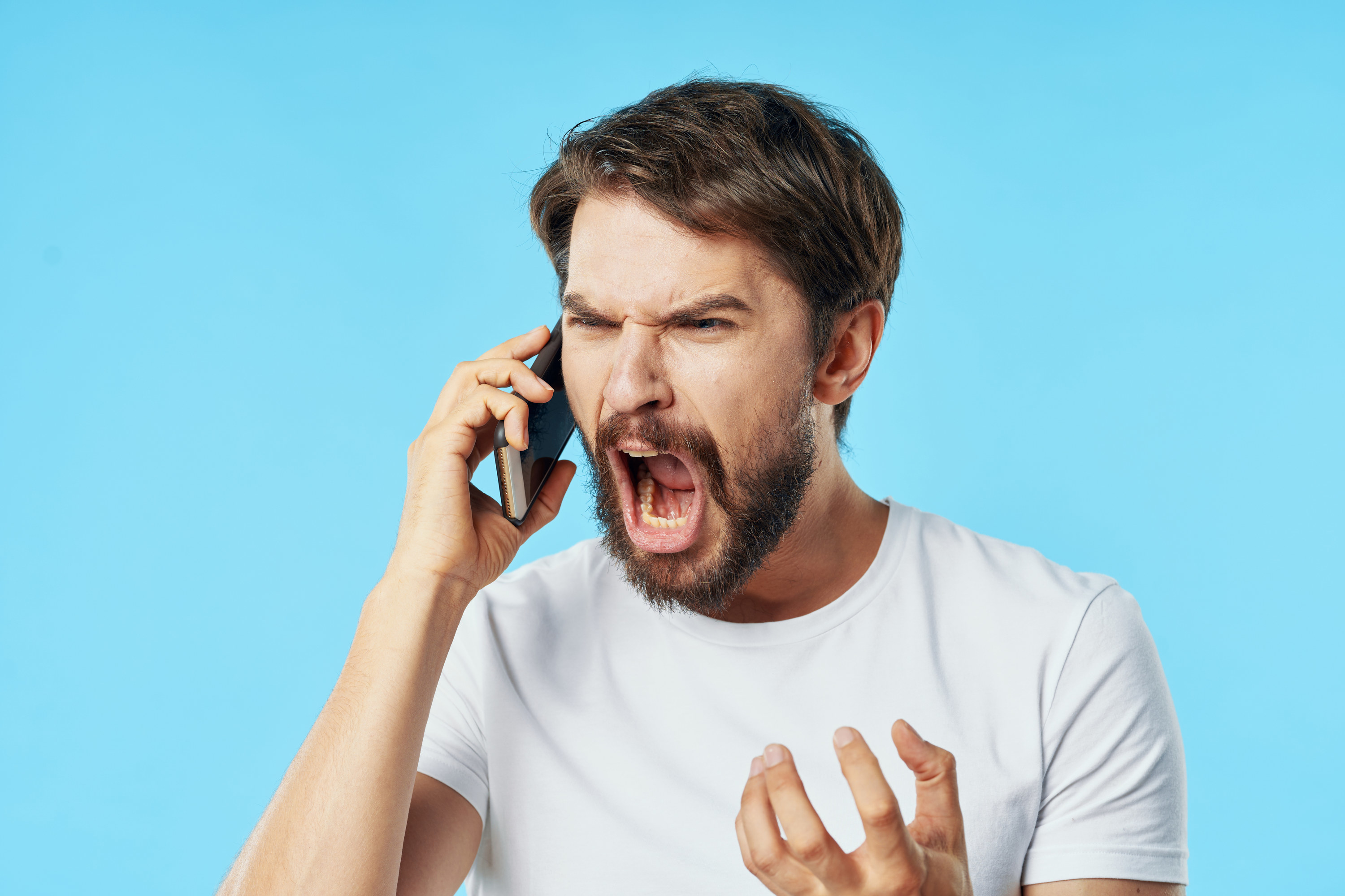 A man yells during a phone call