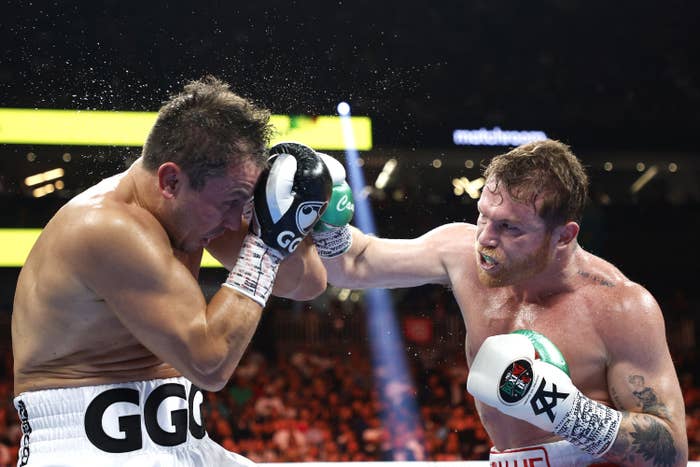 Canelo Alvarez (red trunks) lands a punch against Gennadiy Golovkin (white trunks) in round five of the fight for the Super Middleweight Title