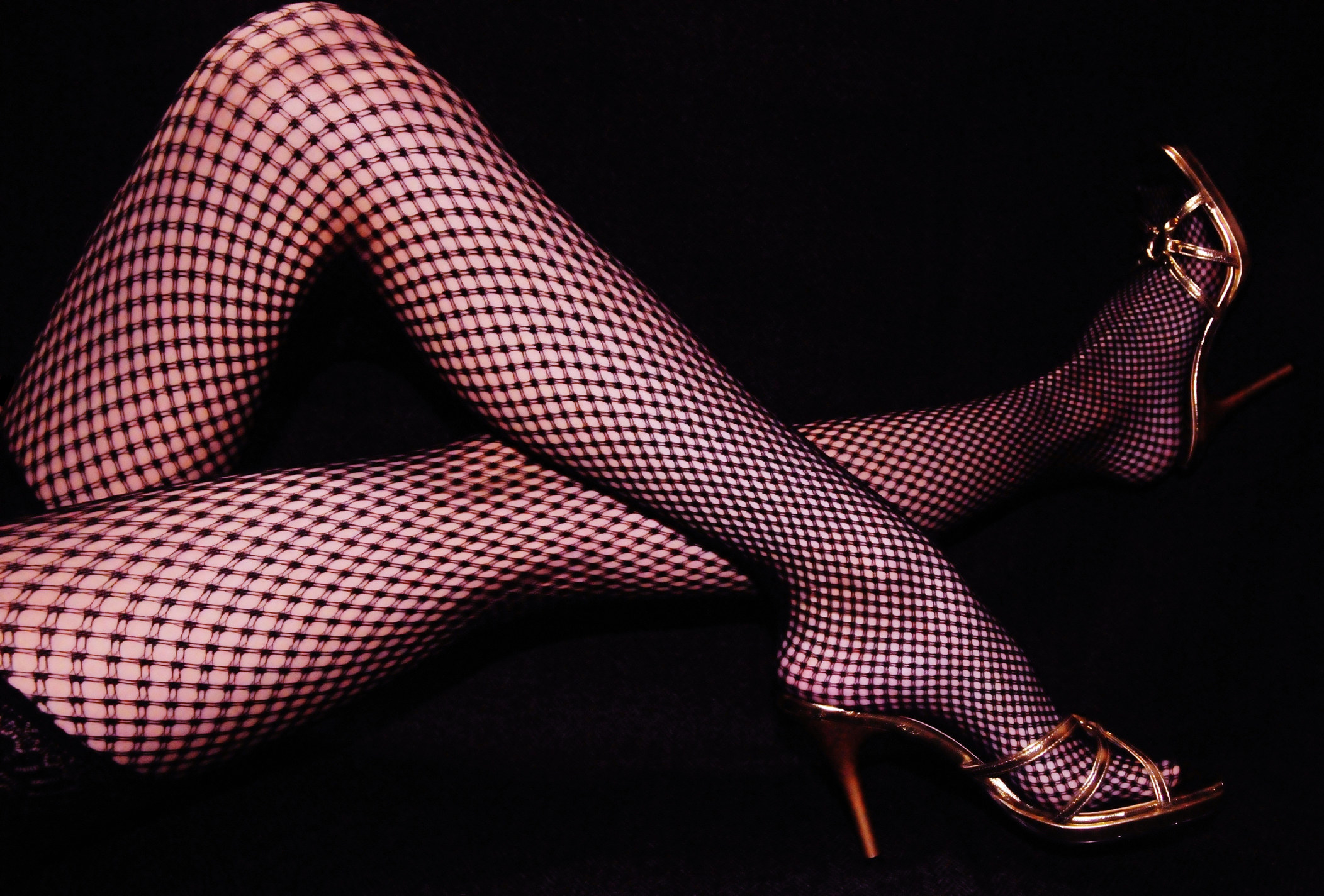 legs in fishnet tights and heels