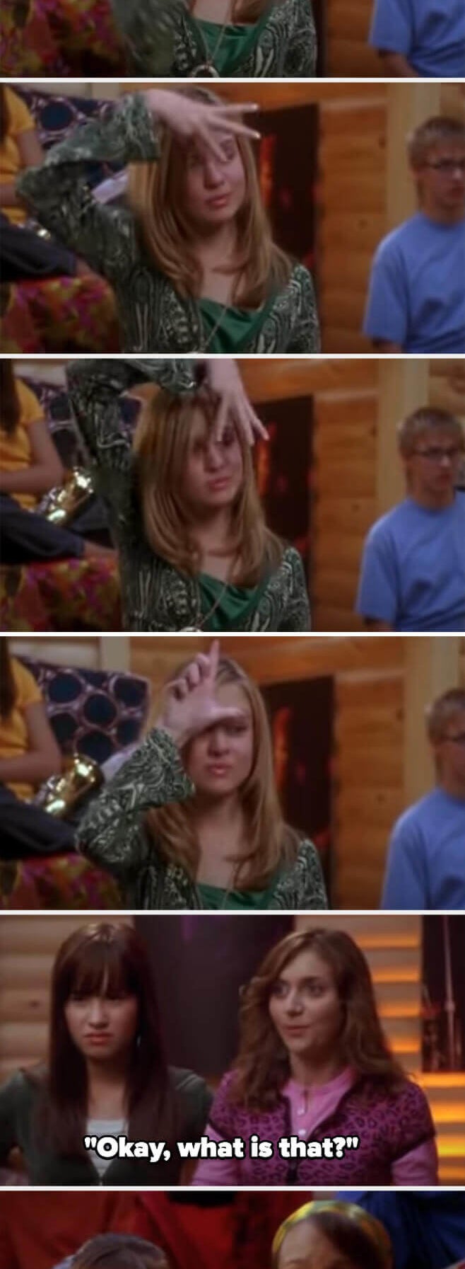 putting a W and an L on her forehead with her fingers