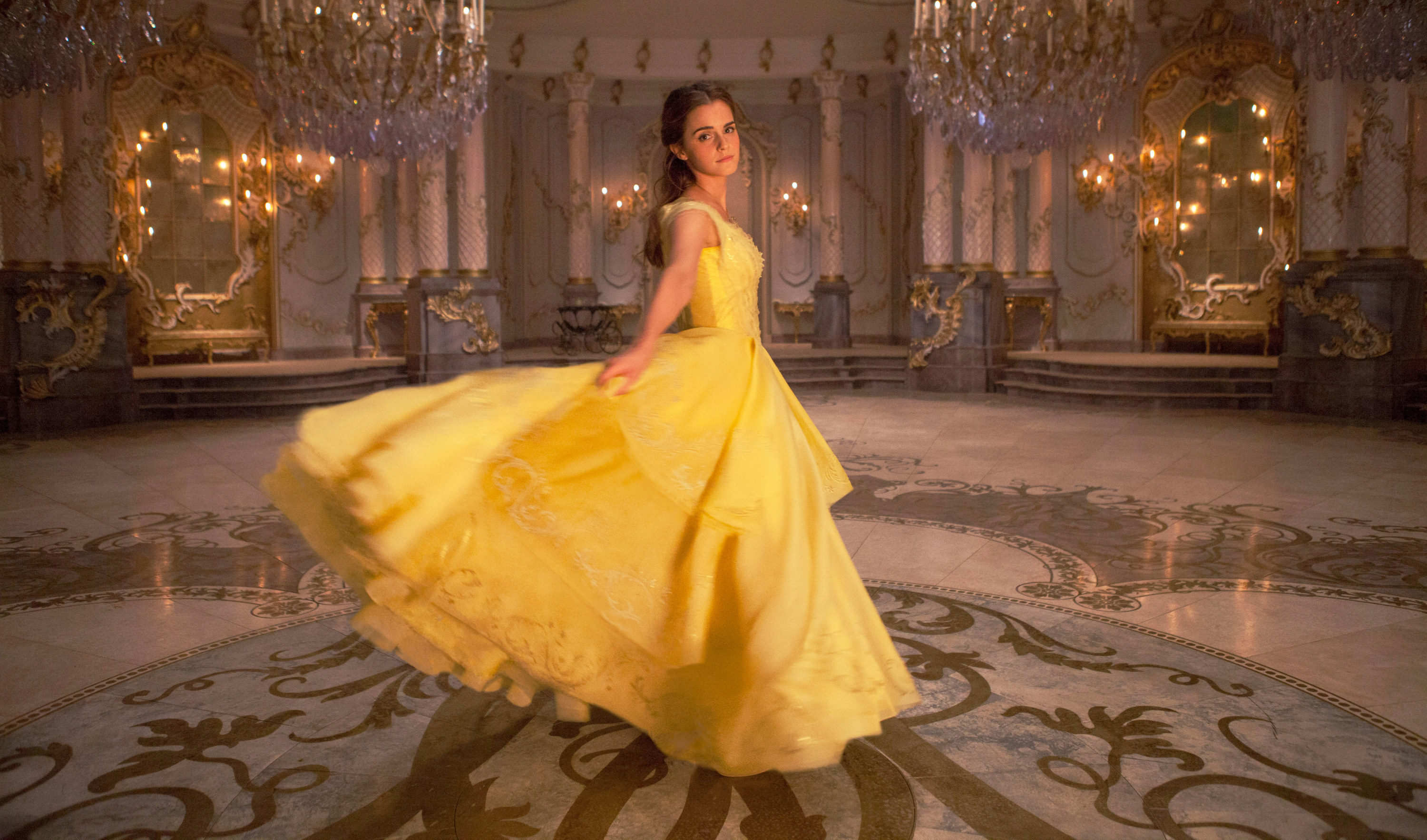 Emma as Belle dancing in a flowing gown