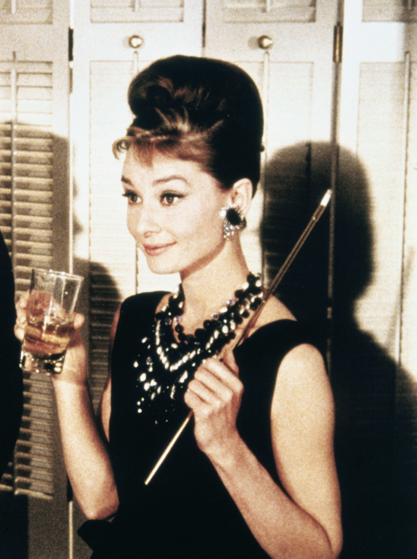 Audrey as Holly holding a glass