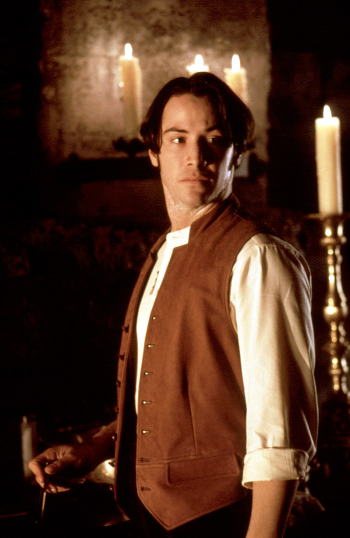 Keanu as Jonathan in a vest and shirt with rolled-up sleeves