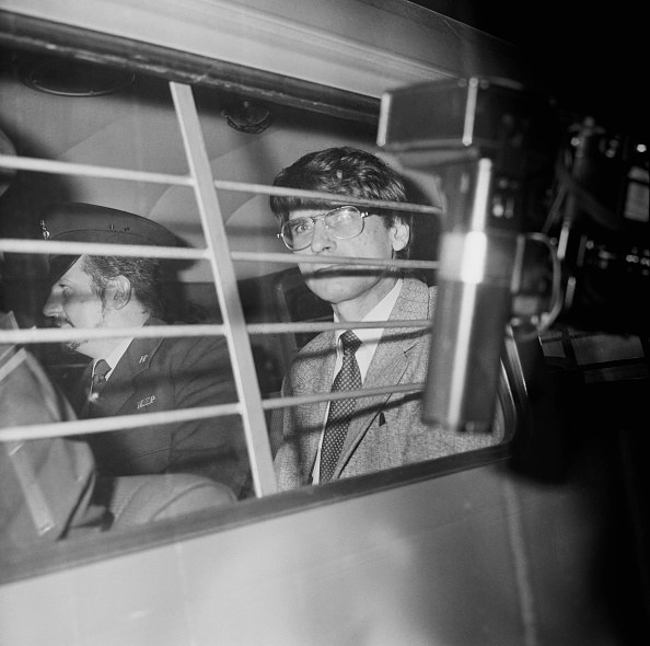 Nilsen being escorted in a police van