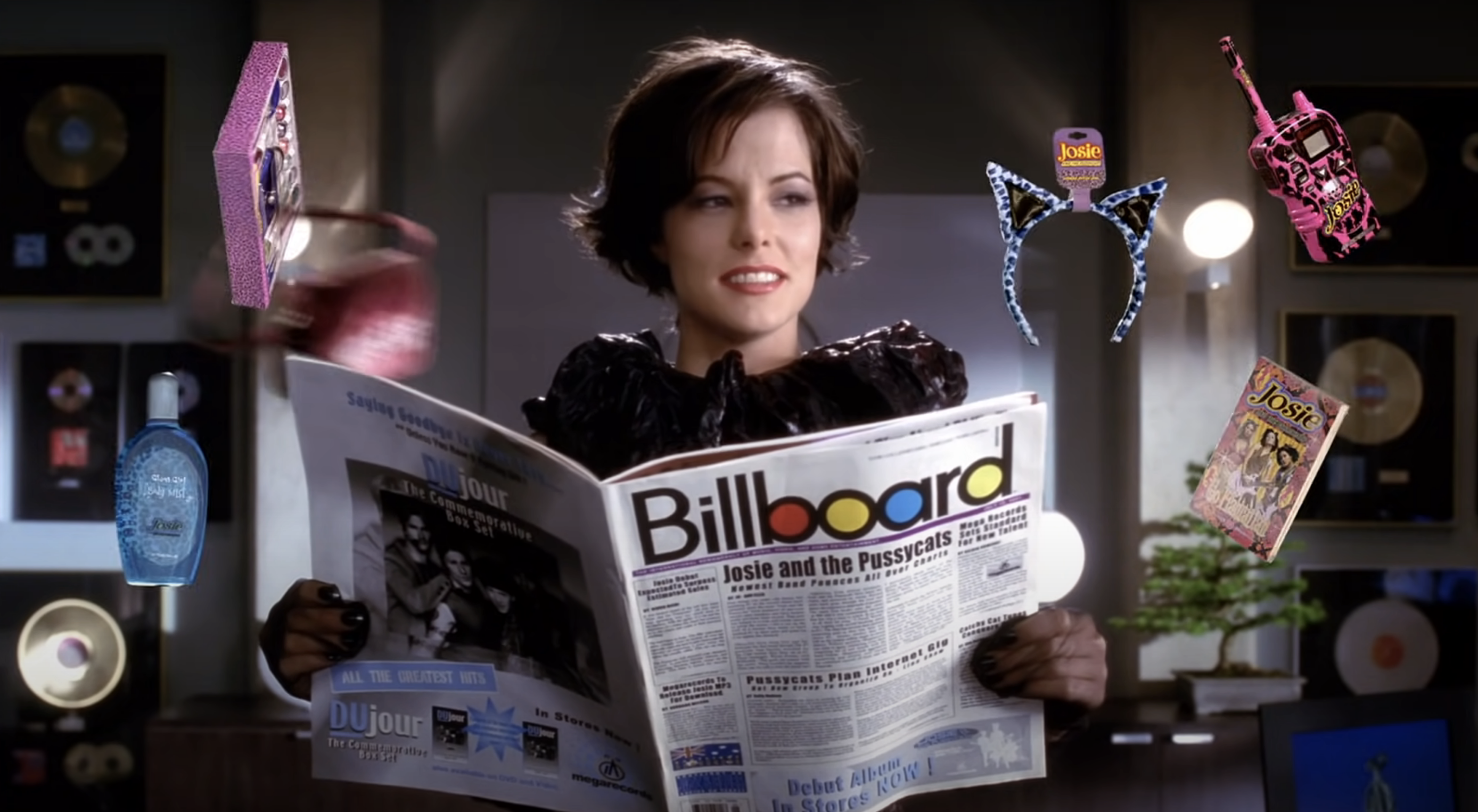 Fiona holding a copy of Billboard with a &quot;Josie and the Pussycats&quot; headline